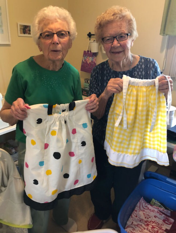 Members of the Mount Calvary United Church in Swift Current displaying some of the skirts they make from recycled linens. These items are then sent overseas to help children in refugee camps.