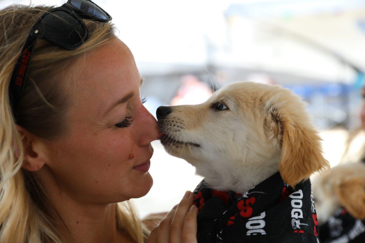 Taryn Nixdorf, with Bright Eyes Dog Rescue, bonds with a puppy.